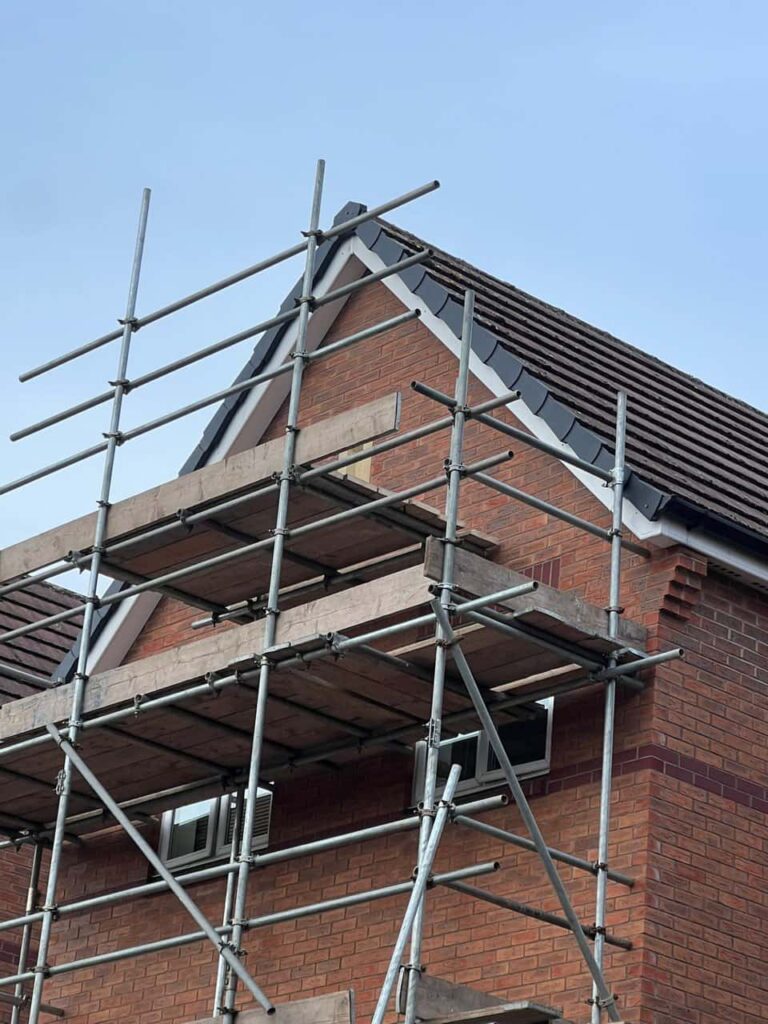 This is a photo of a roof which has just been repaired. There is a scaffold located at the gable end for access onto the roof. Works carried out by Dinnington Roofing Repairs