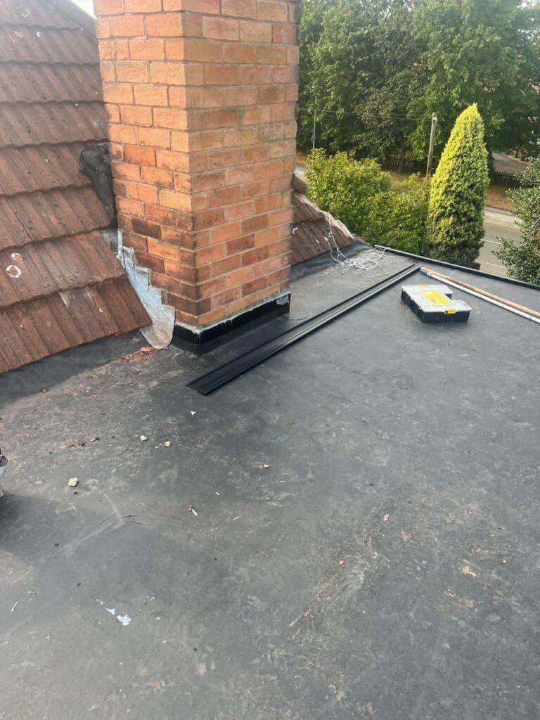 This is a photo of a flat roof which has just been repaired, there is also a chimney stack and some leadwork has also been dressed. Works carried out by Dinnington Roofing Repairs